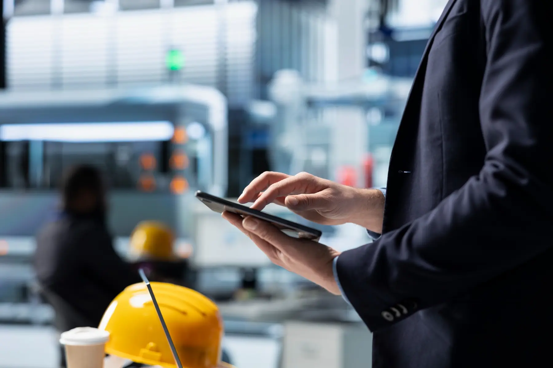 Operations manager using a tablet in an industrial workplace